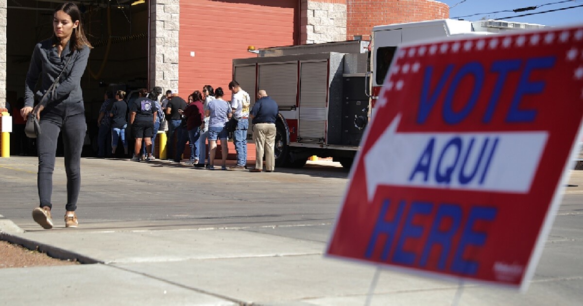 Voters wait in line ouside a fire station polling place in El Paso, Texas, on Tuesday.