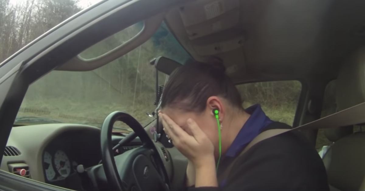Woman crying in her car
