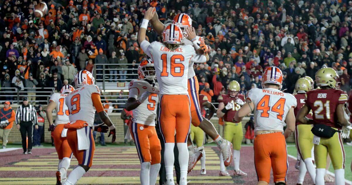 Clemson quarterback Trevor Lawrence (16) celebrates his touchdown run with teammates during Saturday's win at Boston College.