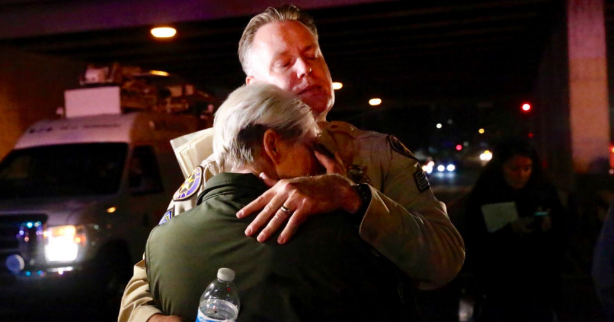 Ventura Co sheriff Sgt Eric Buschow hugs Sgt Julie Novak at the scene of mass shooting at Borderline Bar & Grill.