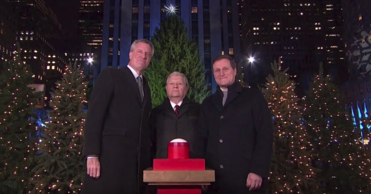 New York Mayor Bill de Blasio, left, was booed when he was introduced during the ceremonial lighting of the Rockefeller Center Christmas tree.