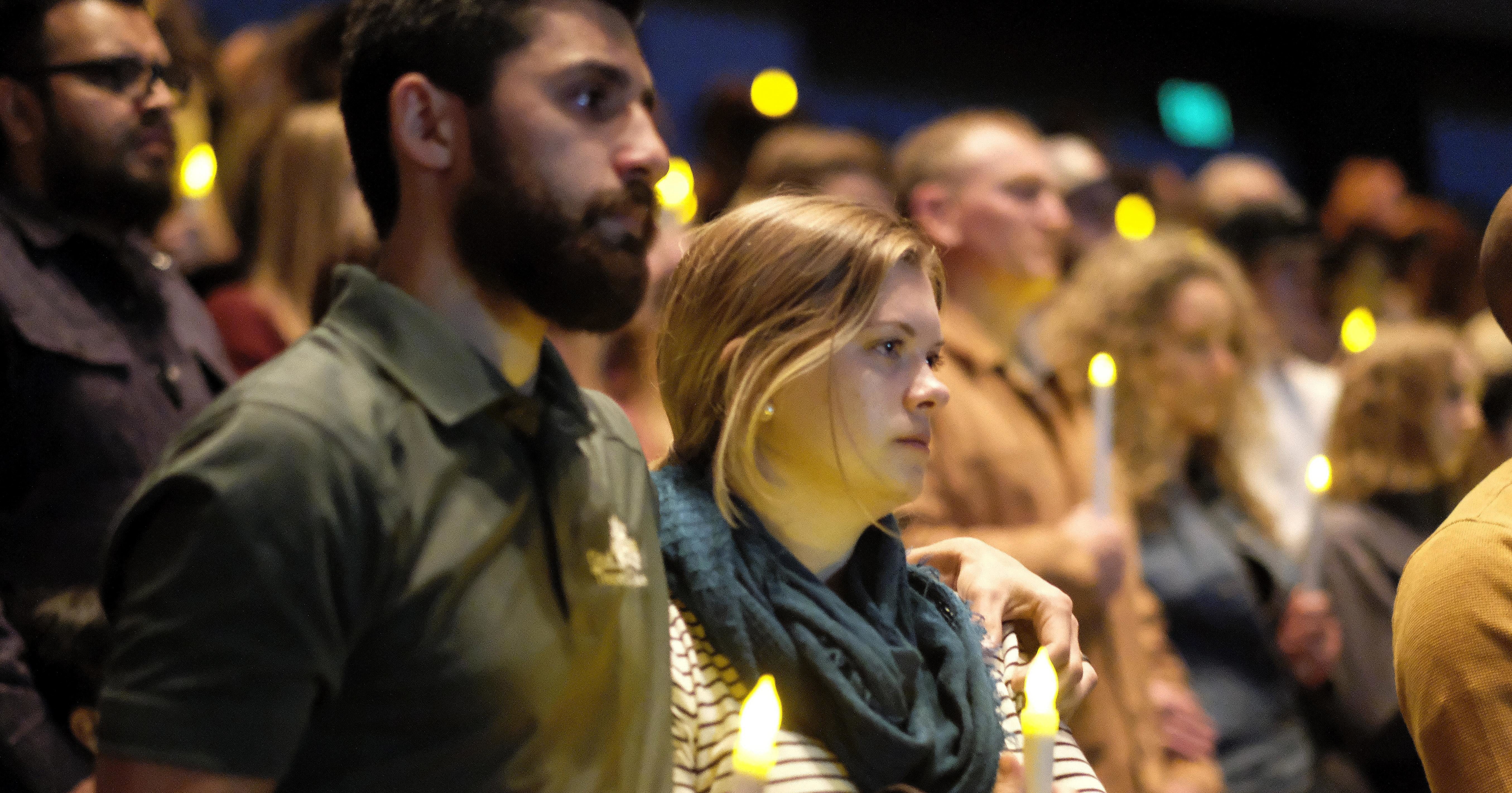 People gather to pray for the victims of the mass shooting during a candlelight vigil in Thousand Oaks , Calif., Thursday, Nov. 8, 2018.