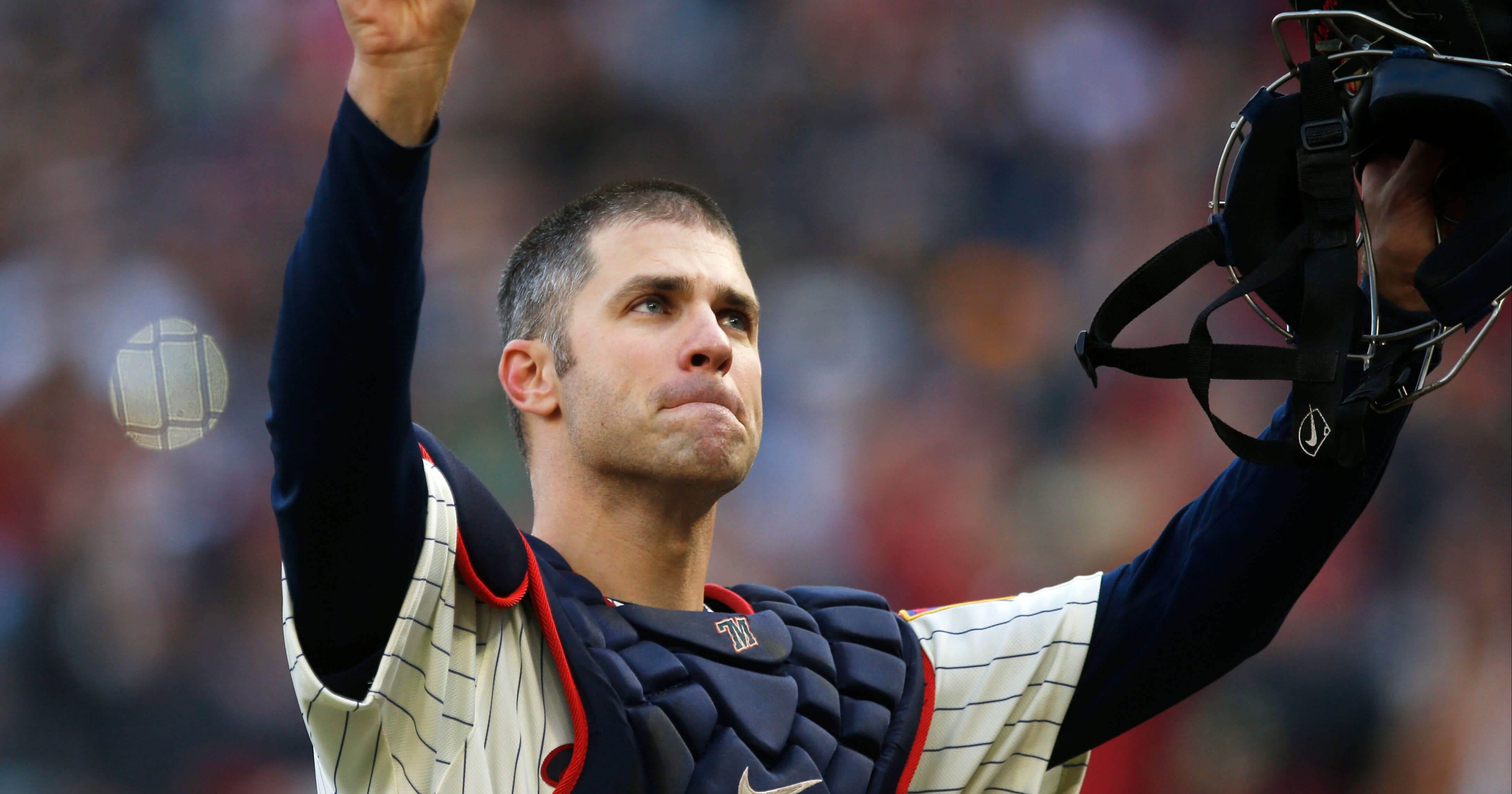 Minnesota Twins' Joe Mauer acknowledges a standing ovation Sept. 30 as he donned catcher's gear and caught for one pitch against a Chicago White Sox batter in the ninth inning of a game in Minneapolis.