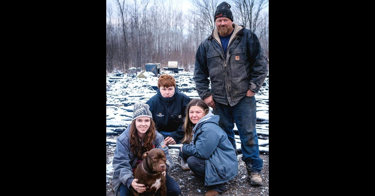 A family with their dog who saved them from a fire.
