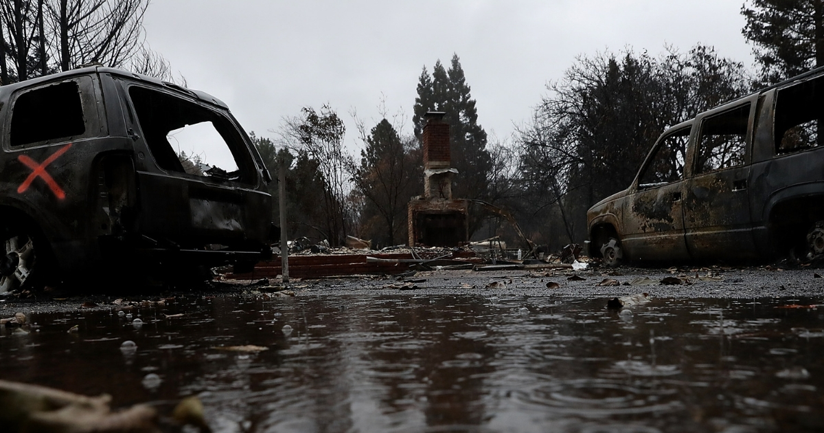 Rain falls on a home destroyed by the Camp Fire on November 22, 2018 in Paradise, California.