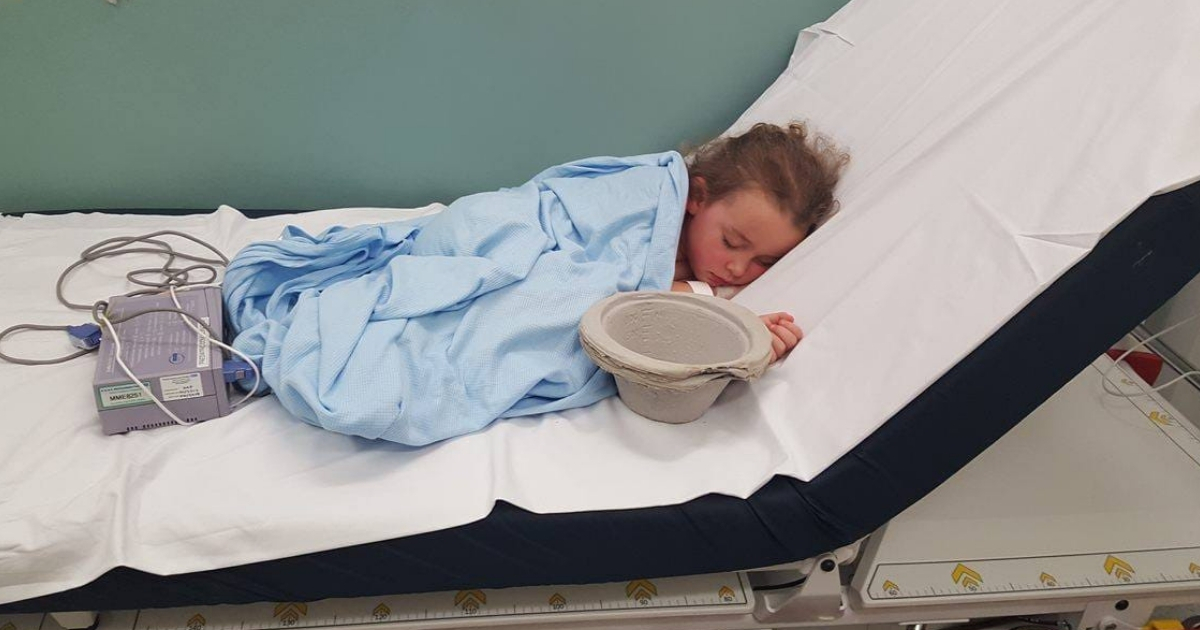 Little girl in hospital bed.