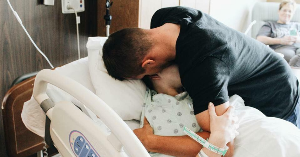 A woman in the hospital being hugged