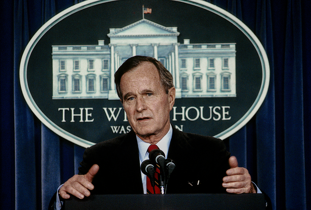 Washington, DC., USA, 1988 President George H.W. Bush talks with and answers reporters questions during a press briefing in the White House Press briefing room.