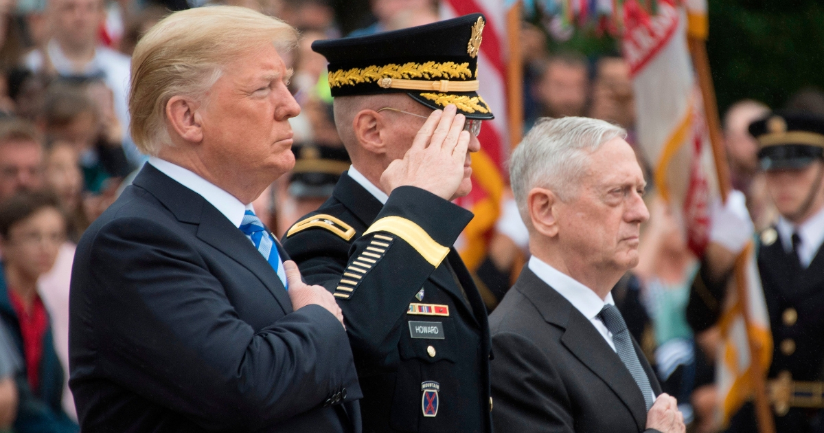 President Donald Trump (L) and Defense Secretary Jim Mattis (3rd L) mark Memorial Day by laying a wreath at the Tomb of the Unknown Soldier.