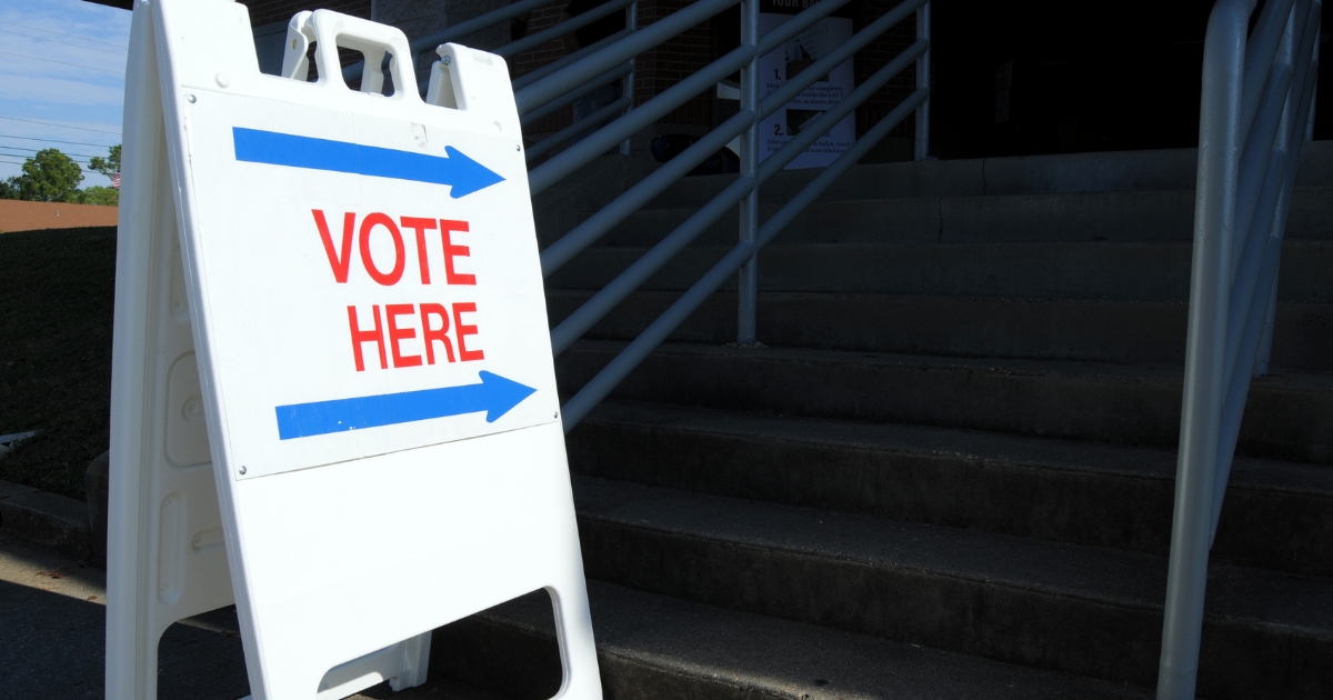 "Vote here" to direct voters to the polling place