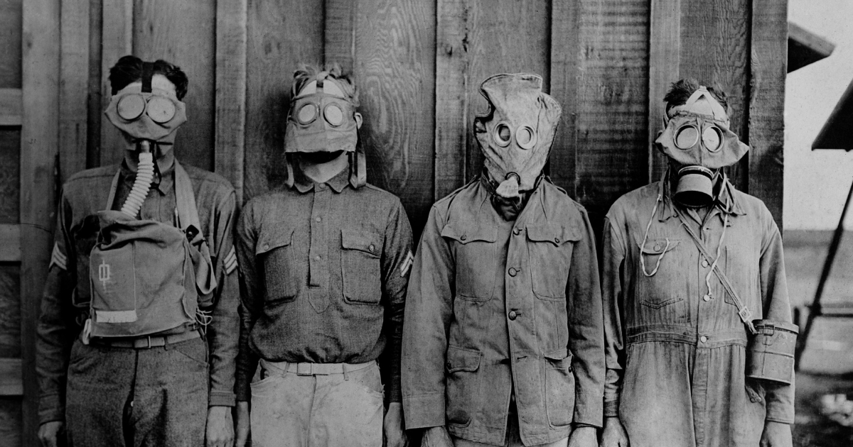 Soldiers wearing WWI gas masks