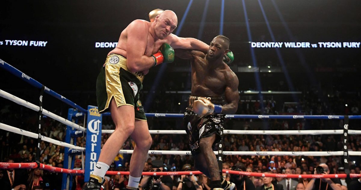 Deontay Wilder, right, connects with Tyson Fury, of England, during a WBC heavyweight championship boxing match Saturday in Los Angeles.