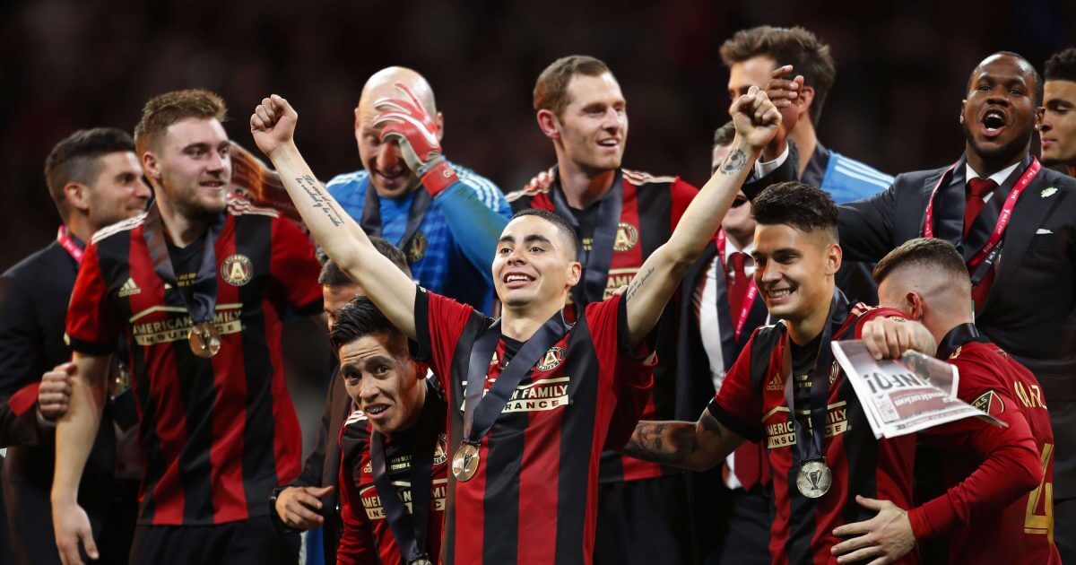 Atlanta United midfielder Miguel Almiron (10) celebrates with his teammates as they take the stage for the trophy presentation after their MLS Cup championship win over Portland on Saturday.