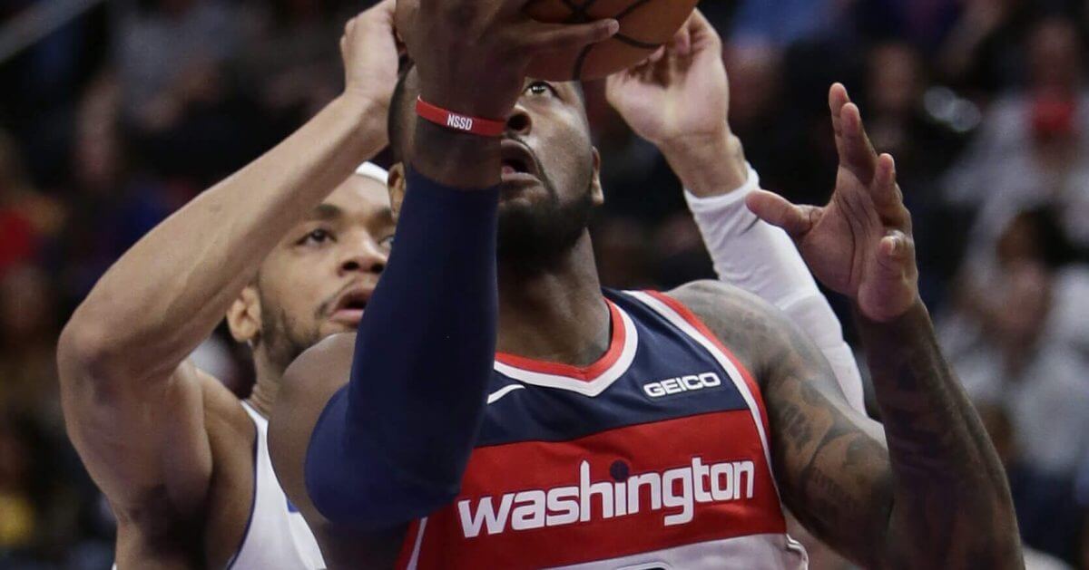 Washington Wizards guard John Wall (2) goes to the basket past Detroit Pistons guard Bruce Brown during the second half of an NBA basketball game on Wednesday in Detroit. The Pistons defeated the Wizards 106-95.