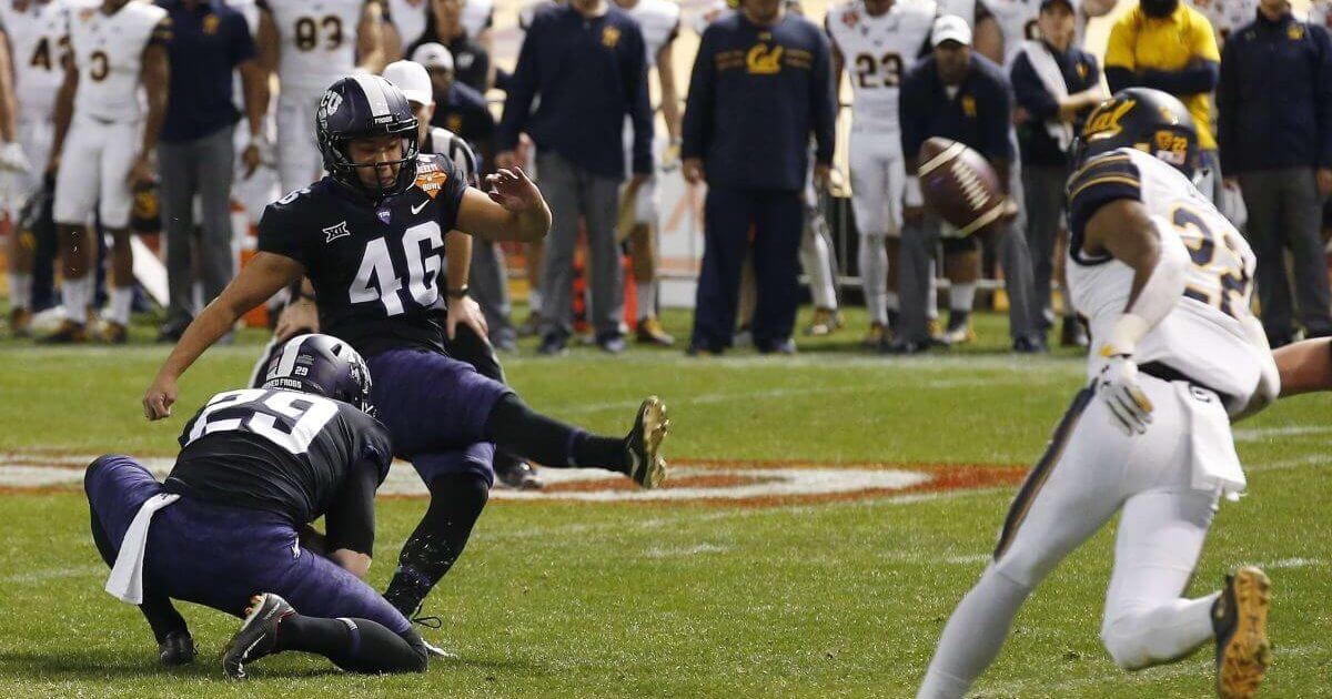 TCU place-kicker Jonathan Song connects for the game-winning field goal from the hold of Adam Nunez as California's Traveon Beck tries in vain to reach the ball during overtime of the Cheez-It Bowl NCAA college football game on Dec. 26, 2018, in Phoenix.