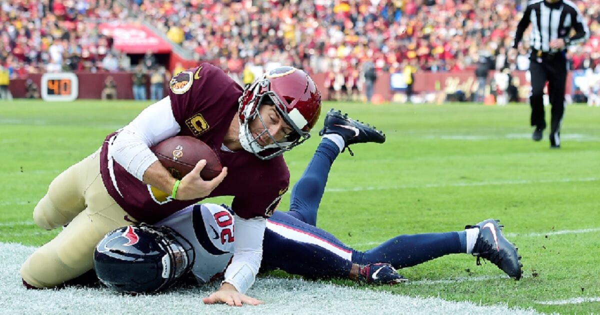 Washington Redskins quarterback Alex Smith is tackled in the first quarter of the team's Nov. 18 game against the Houston Texans in Landover, Maryland.