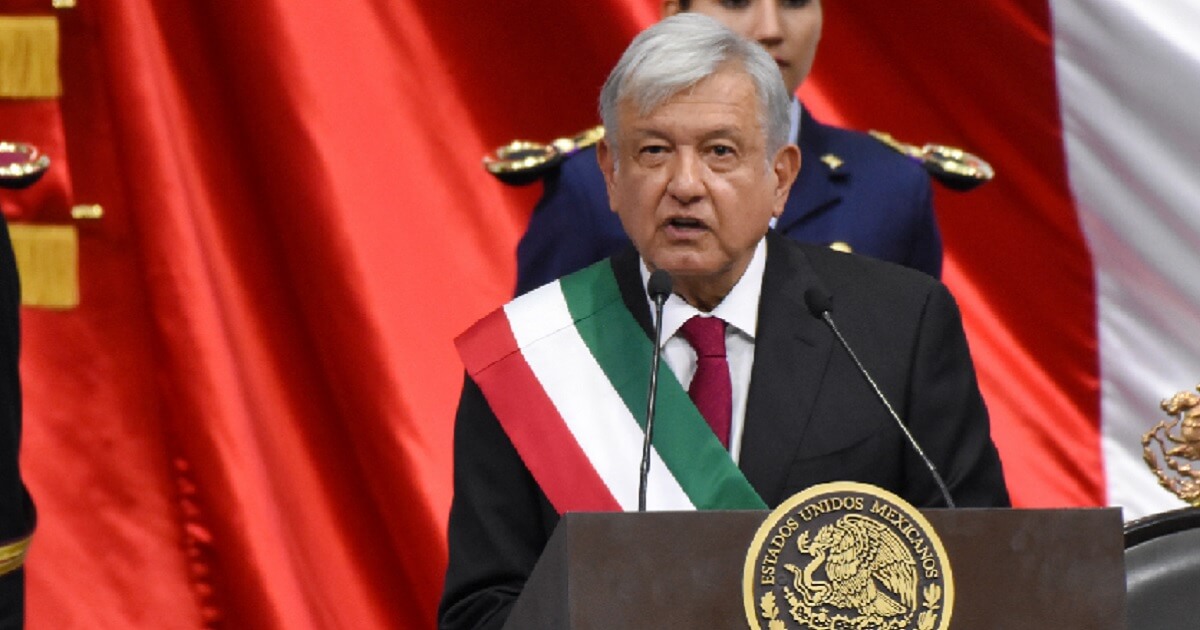 Andres Manuel Lopez Obrador wearing a sash in Mexico's national colors of green, white and red.