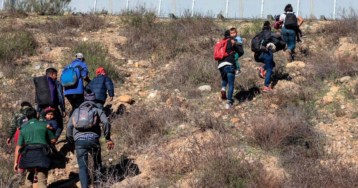 Central American migrants head into California on Sunday after illegally crossing the U.S.-Mexico border near Tijuana.