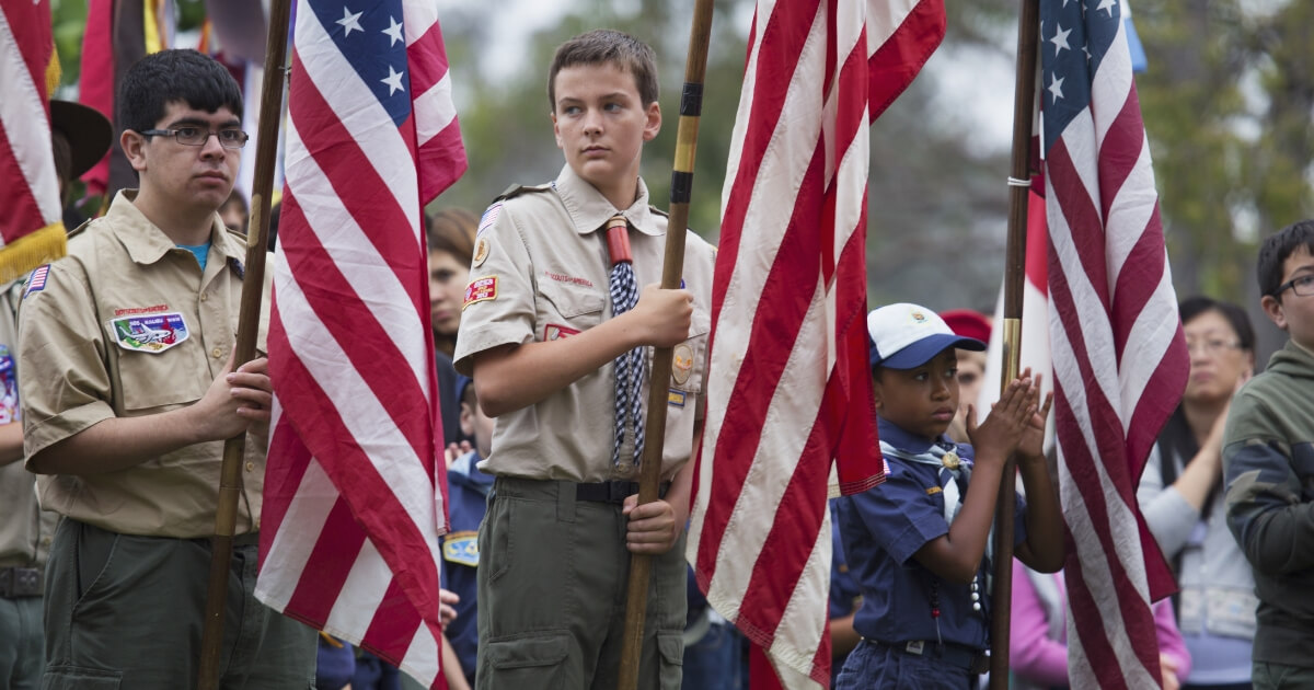 Boy Scouts holding flags.