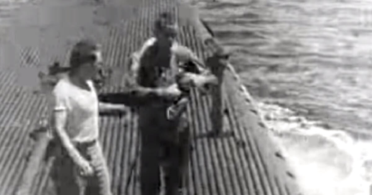 Then Navy pilot George H.W. Bush walks on the deck of the USS Finback submarine after the crew pulled him from the Pacific Ocean in September 1944.
