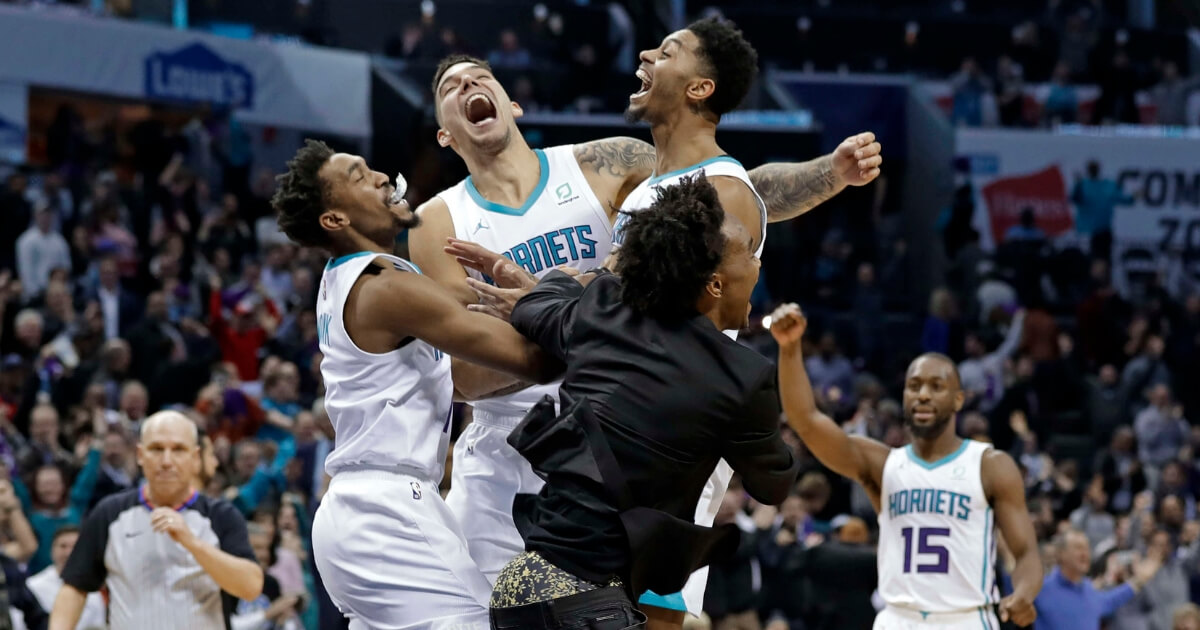 The Charlotte Hornets' Jeremy Lamb, jumping right, celebrates with teammates Malik Monk, left, Willy Hernangomez, center, and Devonte' Graham, front, as Kemba Walker (15) celebrates in background after Lamb's go-ahead and eventual game-winning basket against the Detroit Pistons on Wednesday in Charlotte.