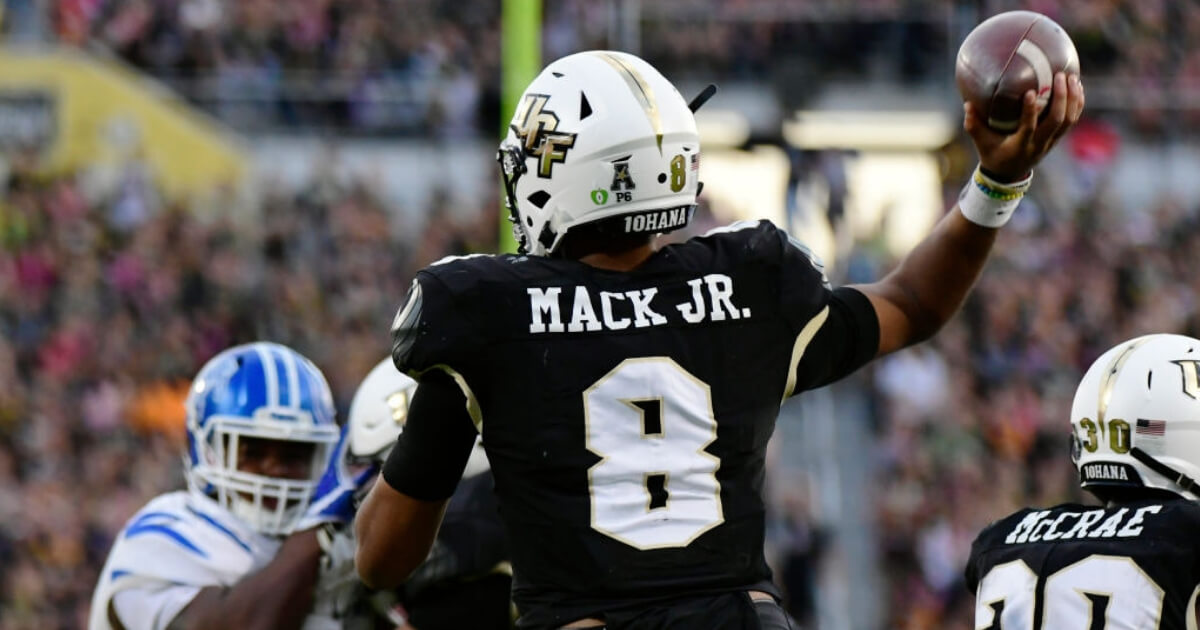 Darriel Mack Jr. of the UCF Knights throws a pass during the American Athletic Conference title game against the Memphis Tigers