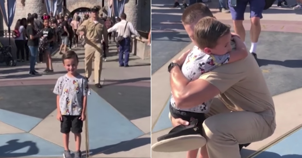 A military dad sneaks up behind his son who is taking a picture in front of the Disneyland castle.