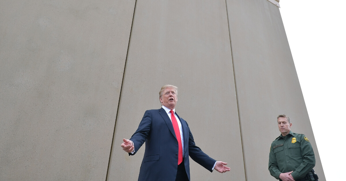 President Donald Trump inspects border wall prototypes with Chief Patrol Agent Rodney S. Scott in San Diego, California, on March 13, 2018.