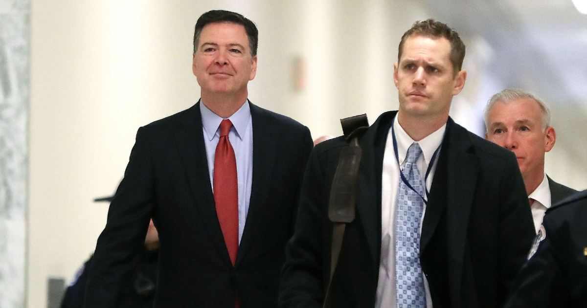 Former FBI Director James Comey, left, arrives at the Rayburn House Office Building in Washington before testifying to the House Judiciary and Oversight and Government Reform committees on Monday.