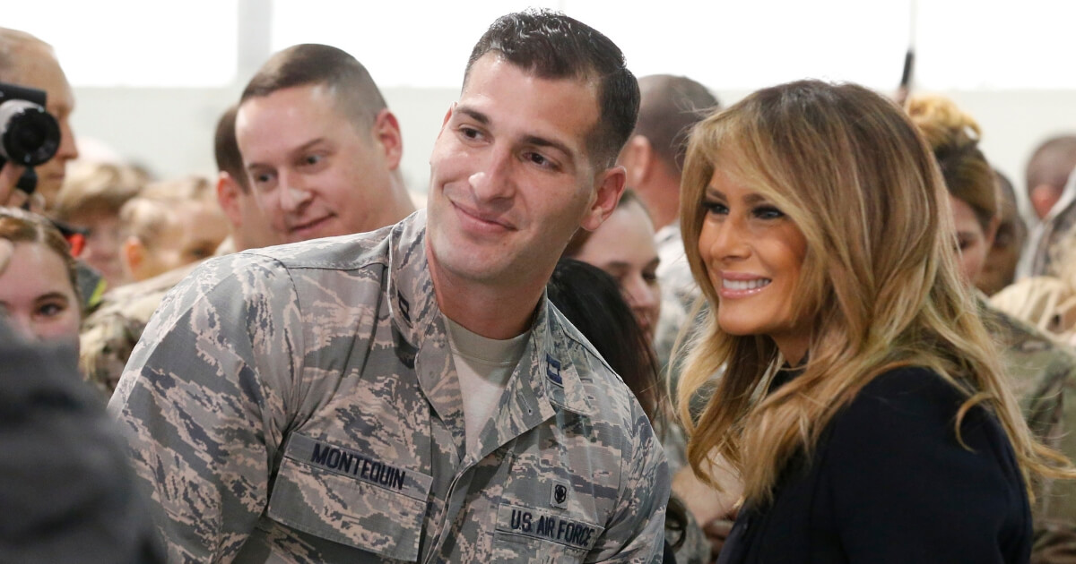 First lady Melania Trump , right, poses with an airman during a tour of Joint Base Langley in Hampton, Virginia, on Dec. 12, 2018.