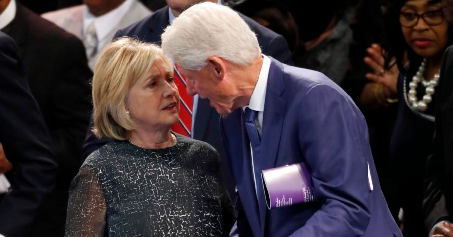 Former President Bill Clinton and wife Hillary Clinton, left, talk during the funeral service for Aretha Franklin at Greater Grace Temple, Aug. 31, 2018, in Detroit.