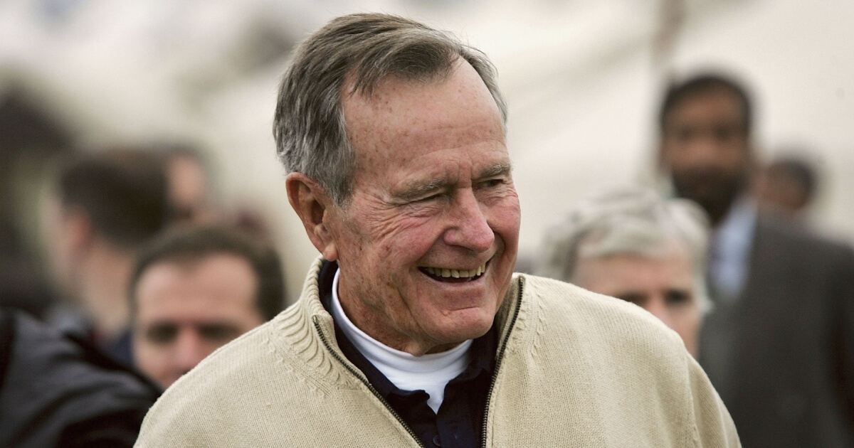 Former U.S. President George H.W. Bush visits a tent camp for earthquake survivors