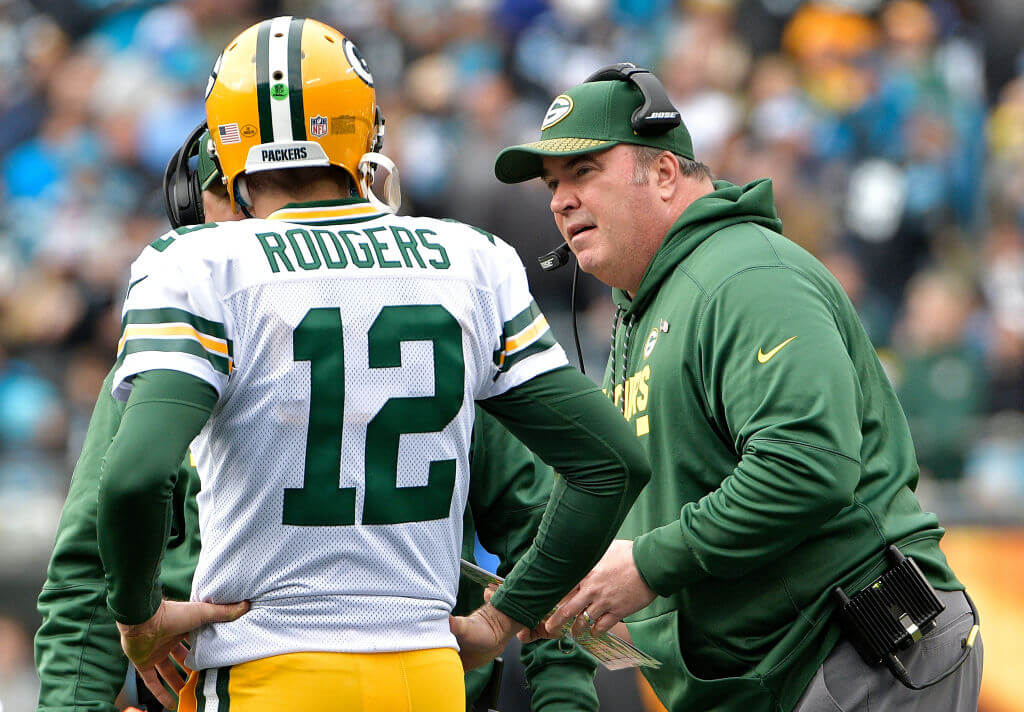 Head coach Mike McCarthy talks to Aaron Rodgers of the Green Bay Packers during a 2017 game against the Carolina Panthers.