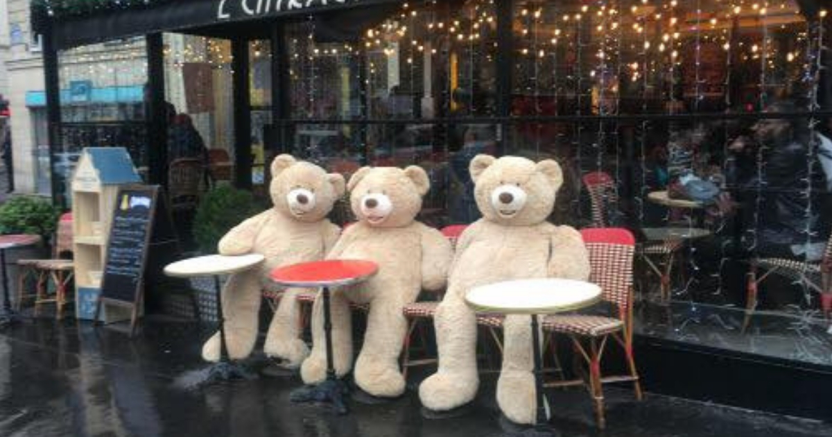 Giant teddy bears outside a restaurant.
