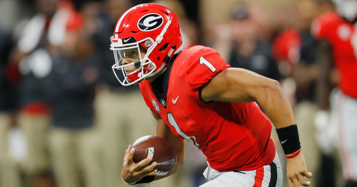 Justin Fields of the Georgia Bulldogs runs with the ball against the Alabama Crimson Tide during the SEC Championship Game on Dec. 1 at Mercedes-Benz Stadium in Atlanta.