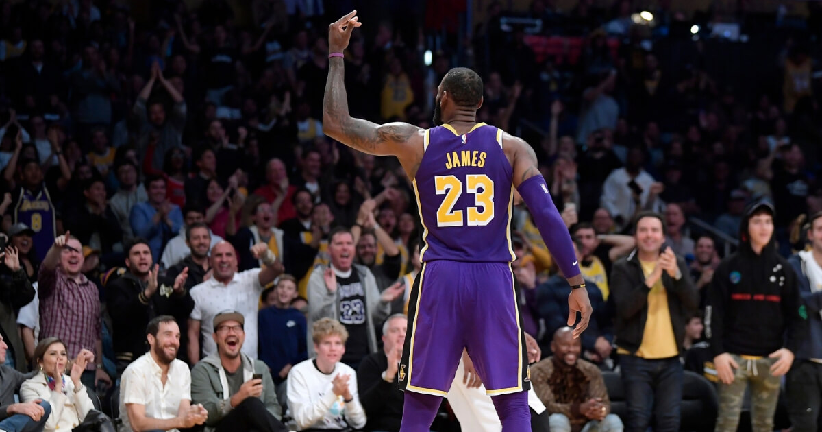 LeBron James gestures to the crowd at Staple Center in Los Angeles after scoring during the second half of Wednesday's game against the San Antonio Spurs.
