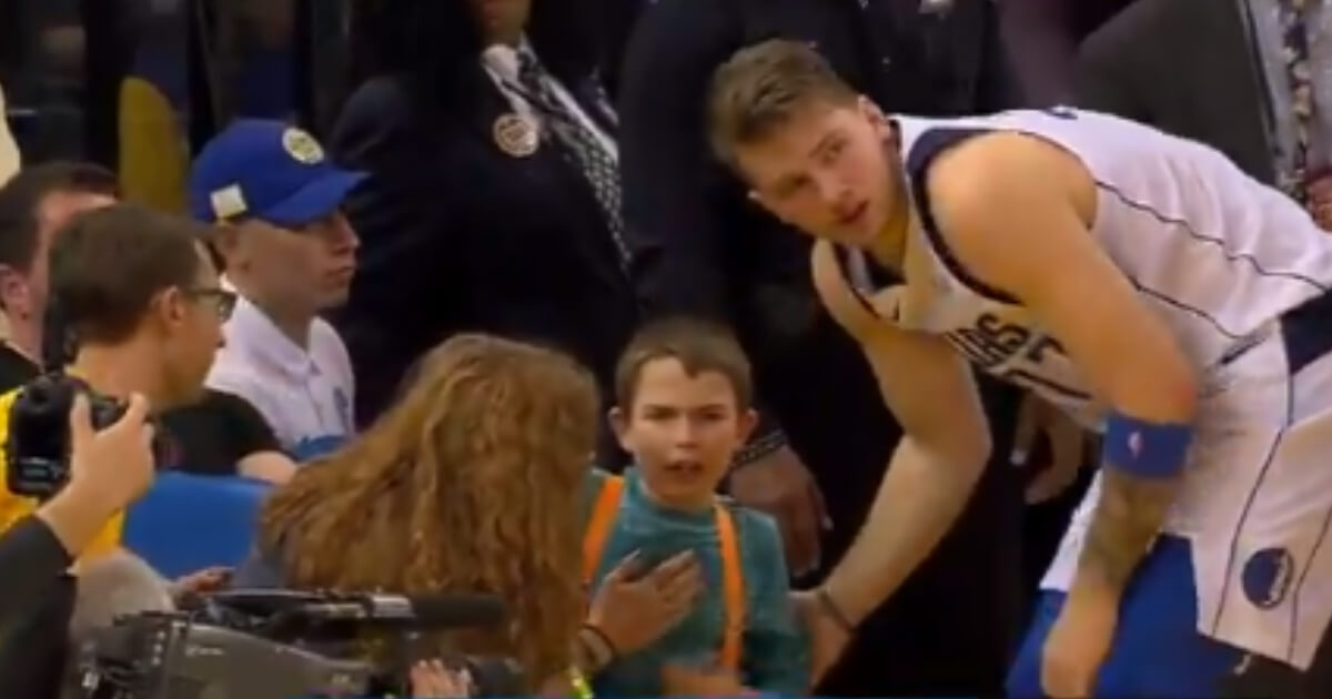 Mavericks rookie Luka Doncic accidentally ran into a young fan sitting courtside during Saturday's game against the Warriors.