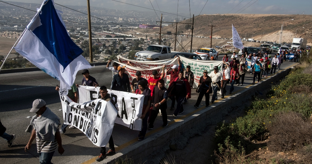 A group of Central American migrants take part in a demonstration march Tuesday in Tijuana, Mexico, heading to the U.S. Consulate to deliver a petition.
