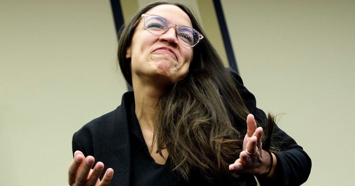 Congresswoman-elect Alexandria Ocasio-Cortez, D-New York, reacts Friday after drawing a lottery number for her new office on Capitol Hill.