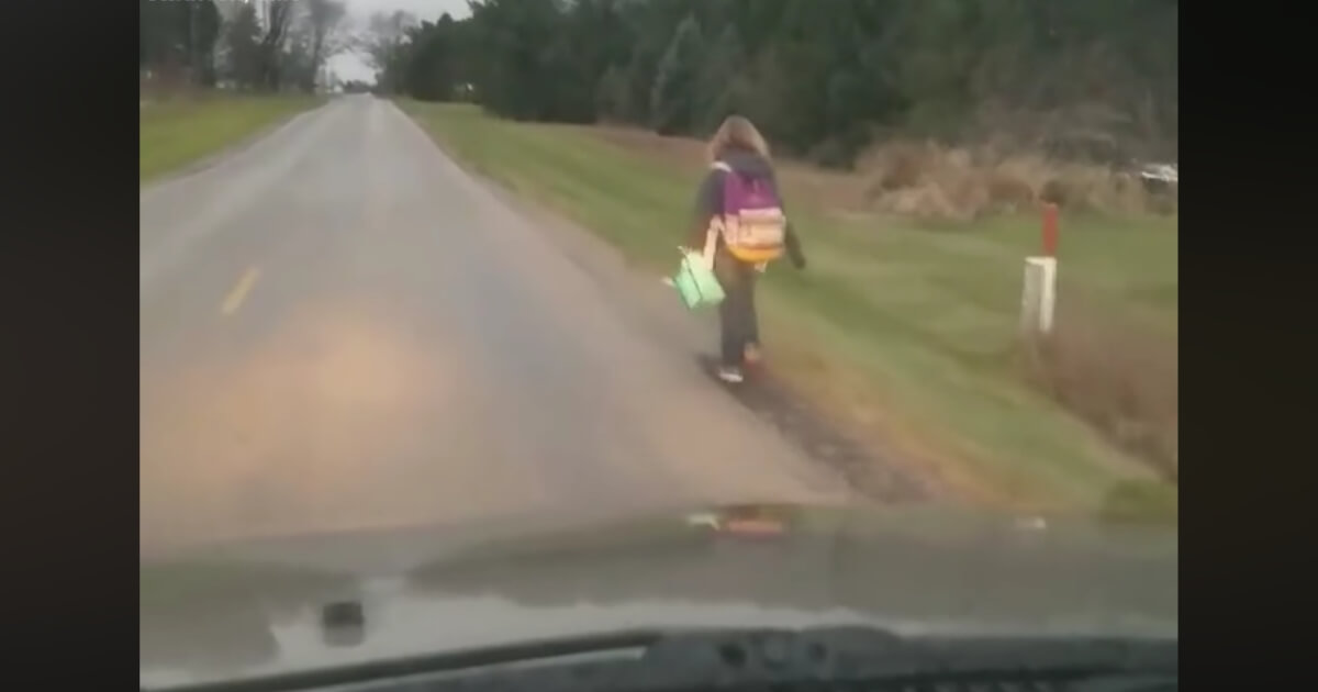Girl walking to school as punishment.