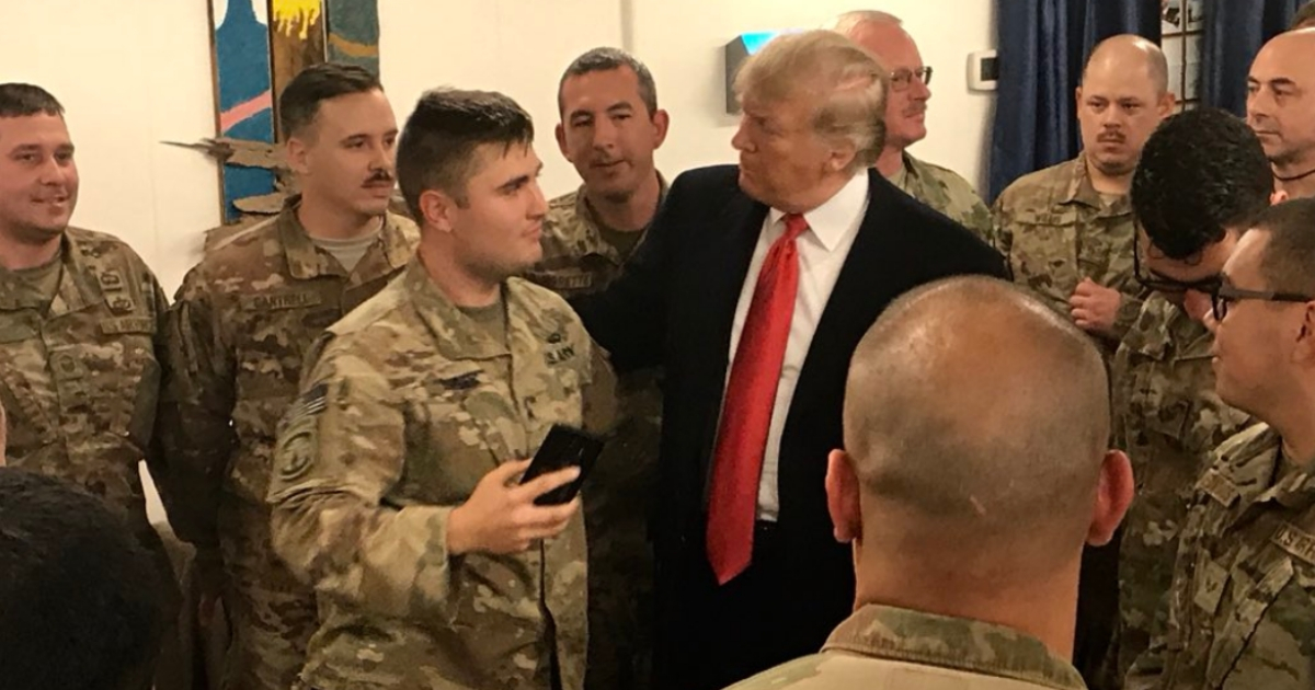 President Donald Trump speaks with the troops