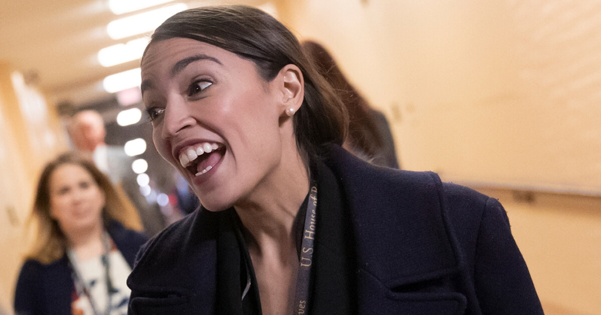 In this photo taken in Washington on Nov. 15, 2018, Rep.-elect Alexandria Ocasio-Cortez, D-N.Y., smiles as new members of the House and veteran representatives gather behind closed doors to discuss their agenda when they become the majority in the 116th Congress.