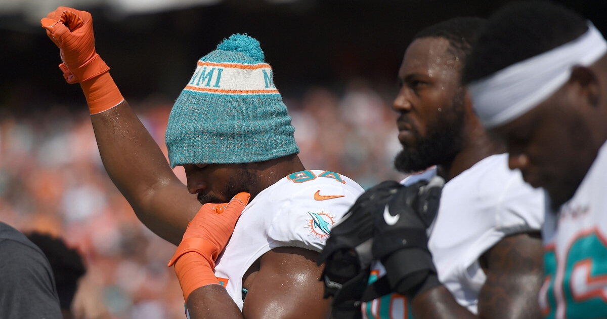 Robert Quinn of the Miami Dolphins raises his first in protest during the playing of the national anthem prior to the start of the team's Oct. 7 game against the Cincinnati Bengals at Paul Brown Stadium.
