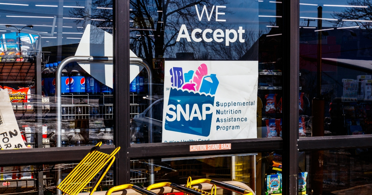 A sign advertises that a food store accepts Supplemental Nutrition Assistance Program benefits.