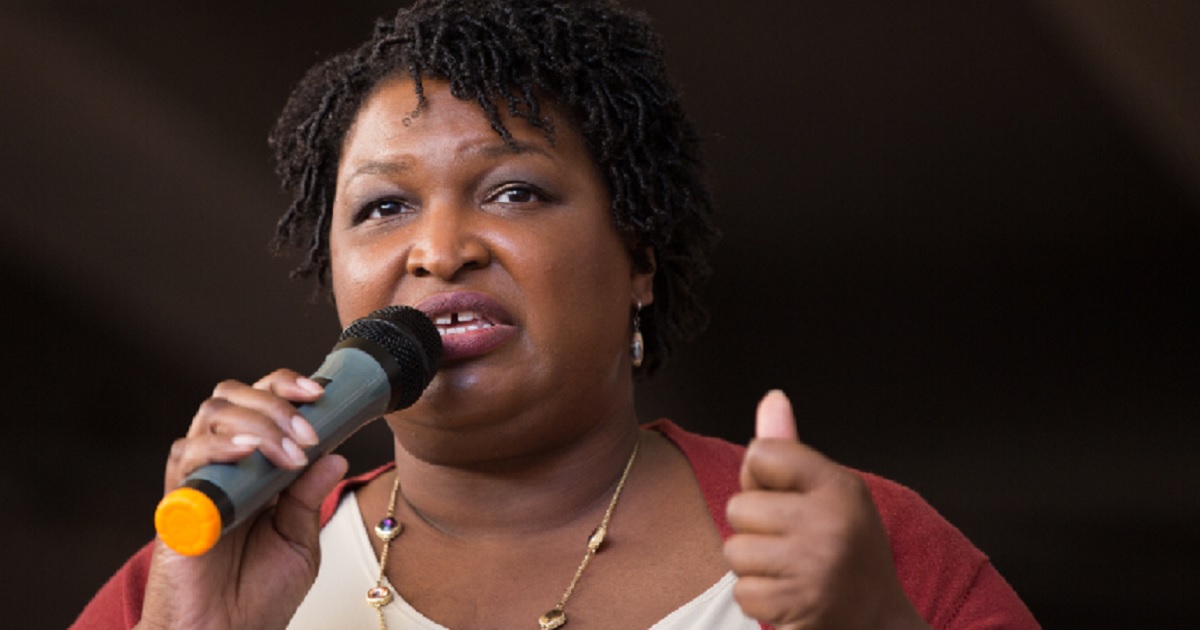 Stacey Abrams speaking into a microphone.