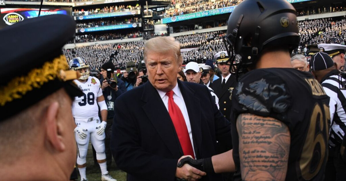 President Donald Trump shakes hands with one of the captains of the Army Black Knights before Saturday's Army-Navy football game in Philadelphia.