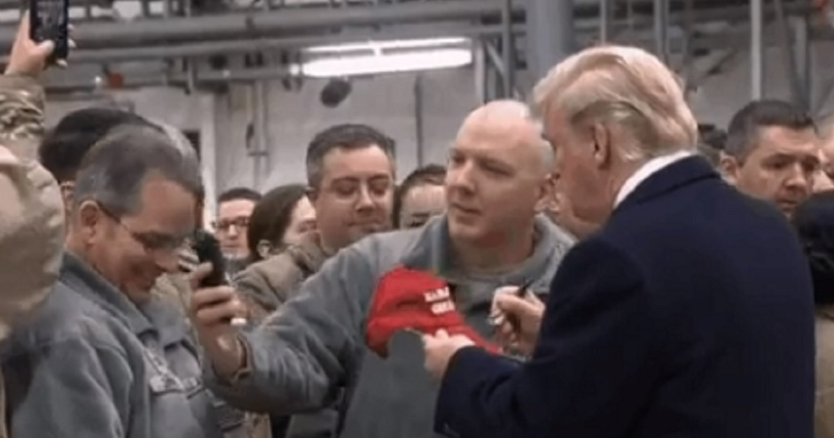 President Donald Trump mingles and signs autographs for the troops in Germany on Wednesday.