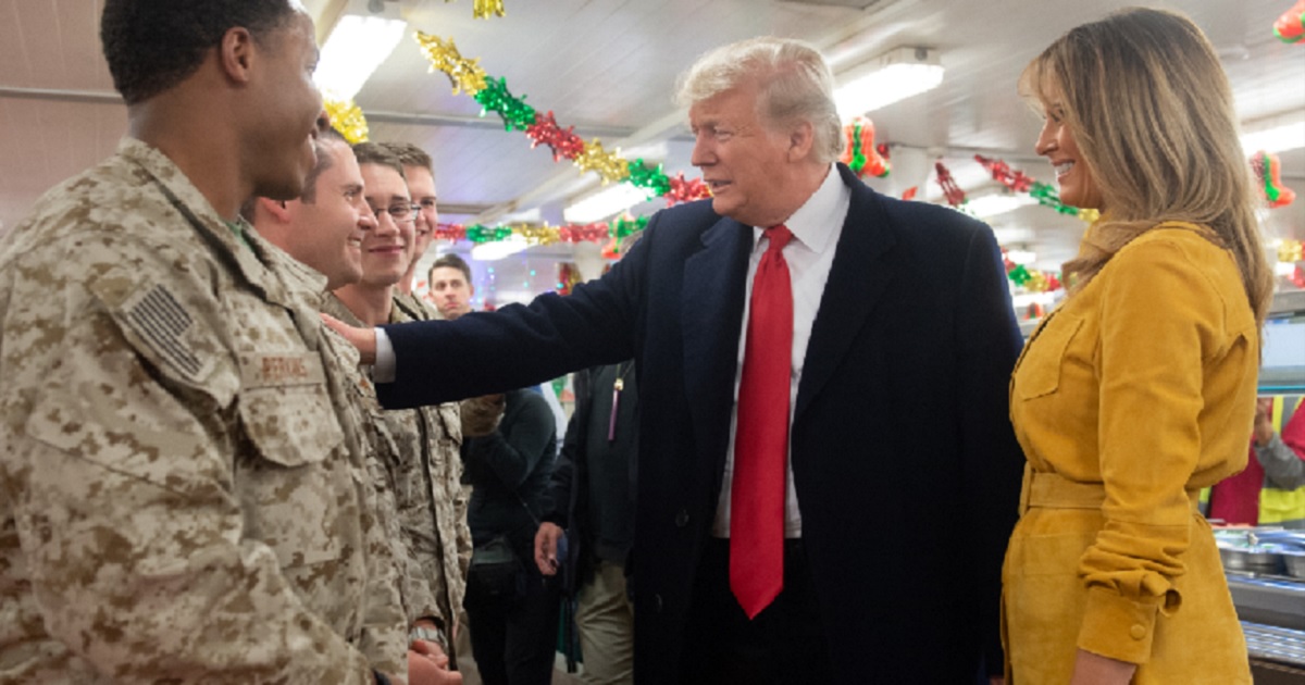 President Donald Trump and first lady Melania Trump talk with soldiers during their Christmas visit to Iraq last week.