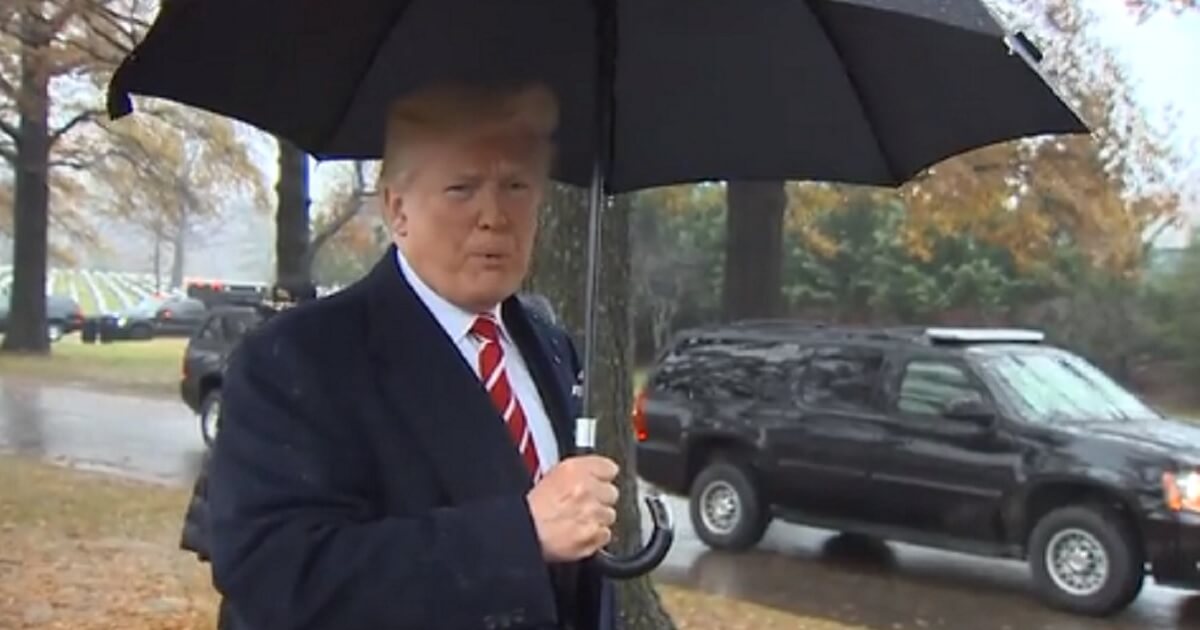President Donald Trump fields questions in Arlington National Cemetery on Saturday.