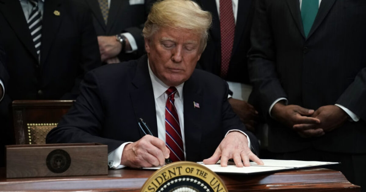 President Donald Trump signs an executive order